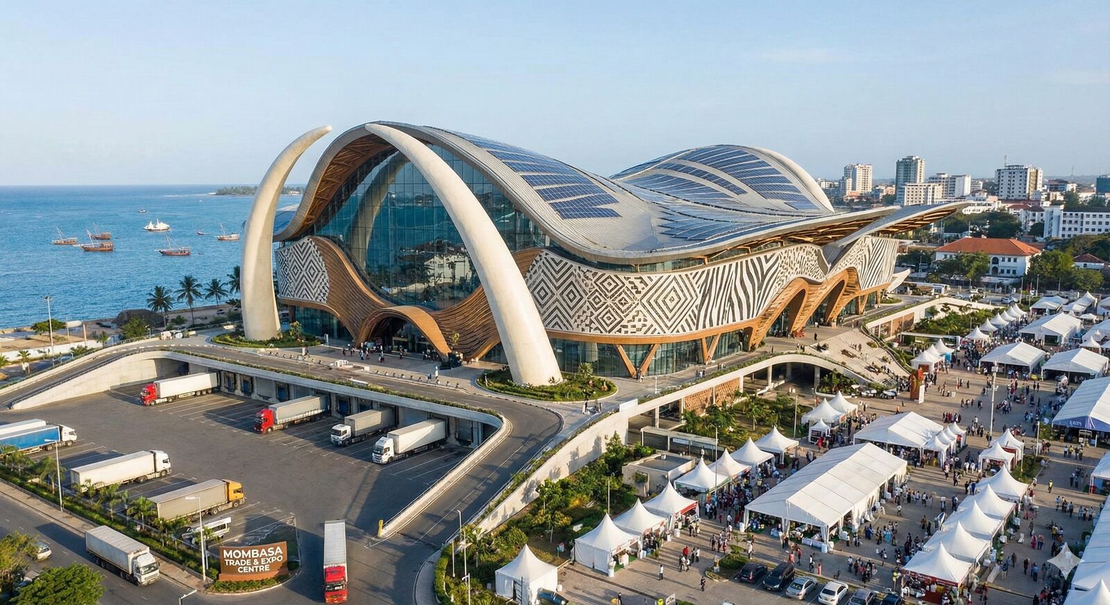 AI-generated concept illustration of a curving convention centre with tusk-shaped arches, a solar roof and zebra-patterned facade on the Mombasa waterfront, with exhibition tents and lorries in the foreground